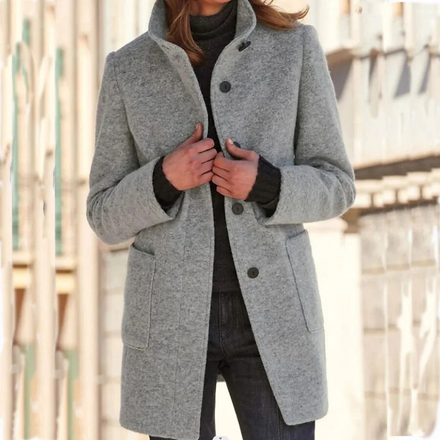 Women's elegant classic buttoned winter coat. Warm long overcoat with a stylish standing collar.