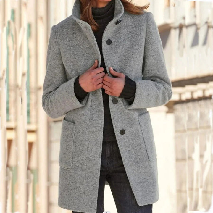Women's elegant classic buttoned winter coat. Warm long overcoat with a stylish standing collar.