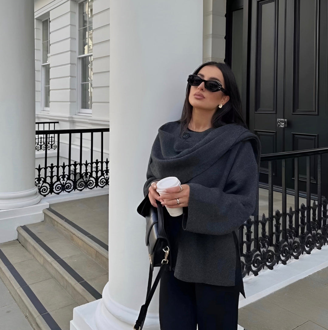 Asymmetrical women's fashion poncho, elegant layering for a chic winter style.