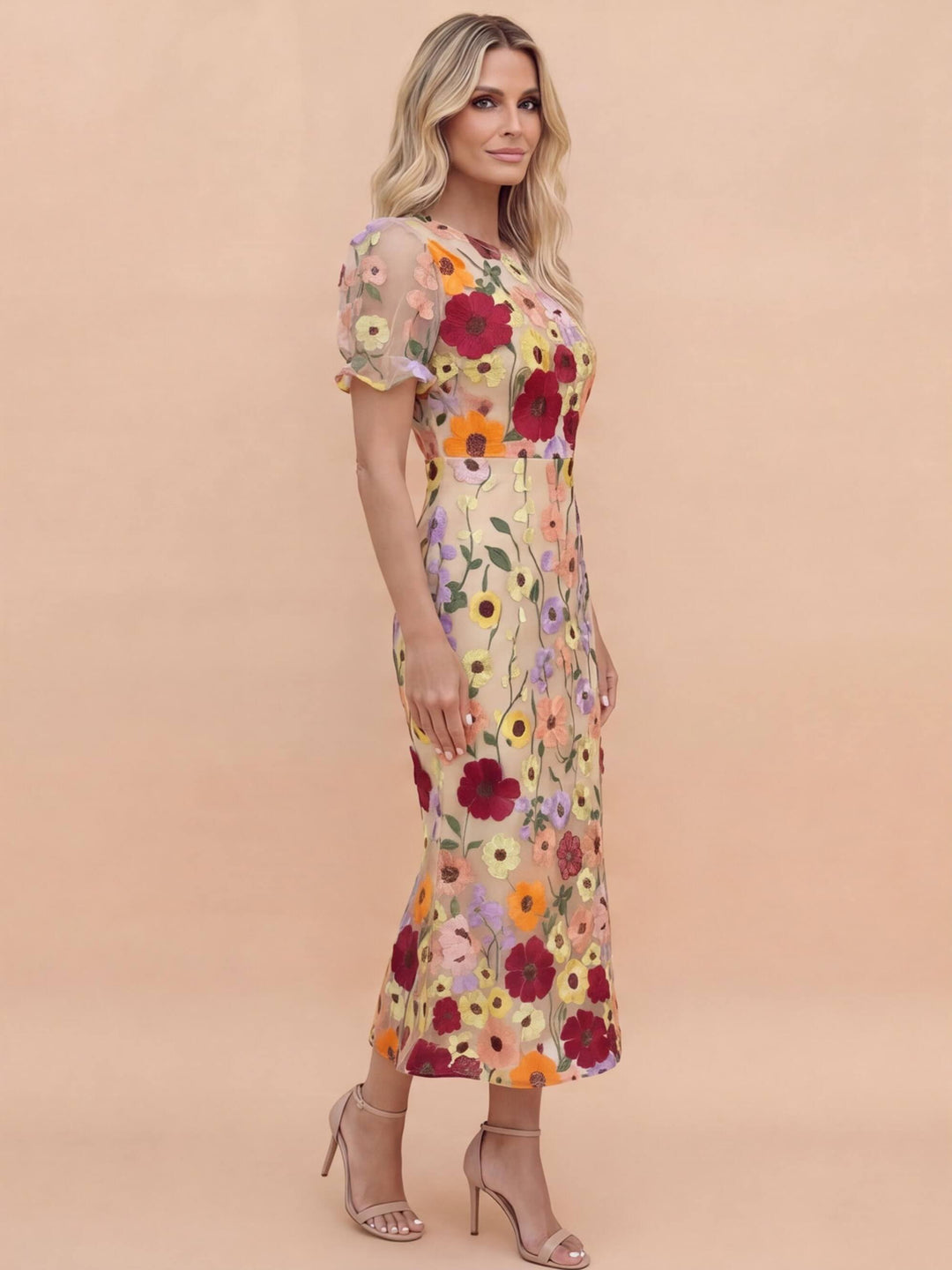 Close-up of intricate pink floral applique on a chic women's midi dress, ideal for spring races.