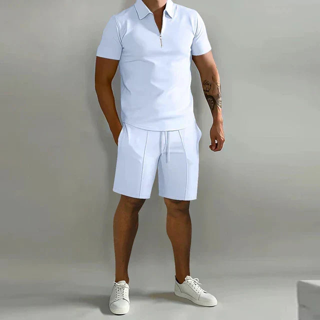 Stylish man modeling a men's luxury summer polo and shorts set. Perfect two-piece outfit for resort & casual wear.