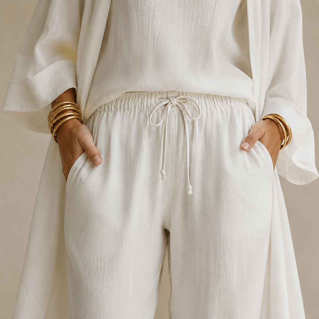 Model wearing comfy women's 3-piece loungewear set with wide leg pants, duster cardigan & cami.