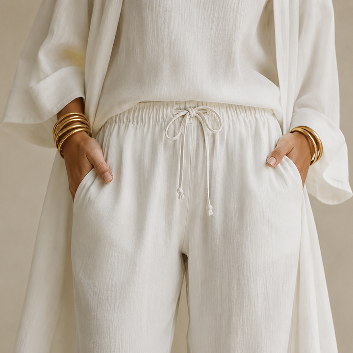 Model wearing comfy women's 3-piece loungewear set with wide leg pants, duster cardigan & cami.