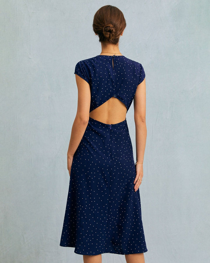 Stylish women's navy polka dot midi dress with unique cut-out and cap sleeve design for a flattering fit.
