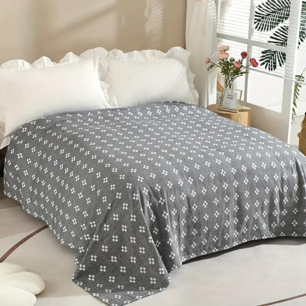 Unisex soft cotton throw blanket featuring a chic geometric pattern, great for a snug home decor accent.