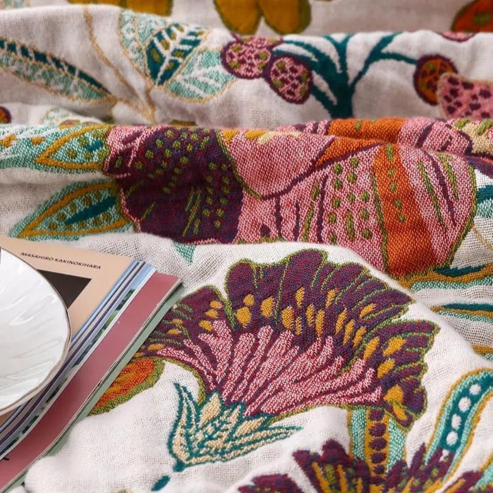Durable & cozy all-season reversible floral cotton throw blanket, perfect for sophisticated home decor.
