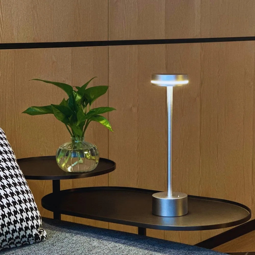 Elegant rechargeable LED table lamp featuring touch dimming & cordless design for flexible placement.