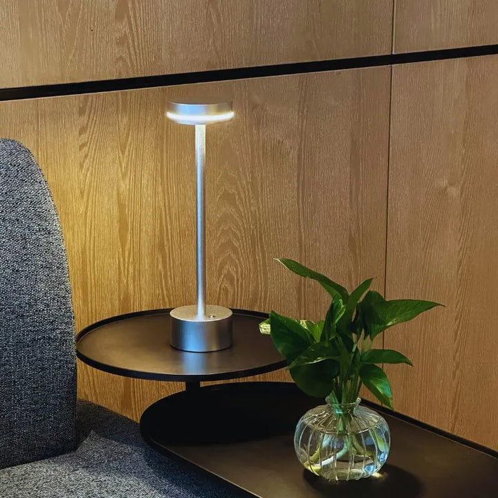 Compact portable LED lamp, rechargeable and touch dimmable, designed for convenience and style.