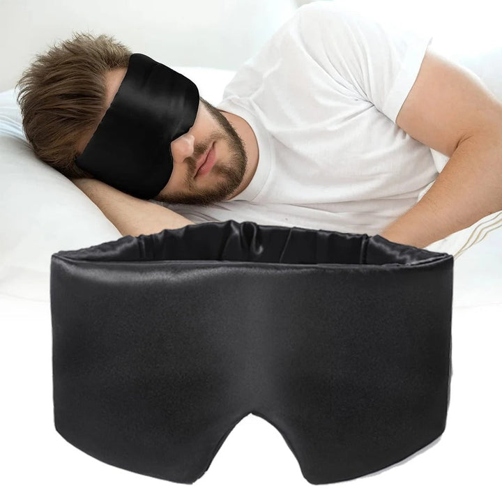 Soft mulberry silk sleep mask, black color, showing smooth fabric texture. Luxury eye mask for relaxation.