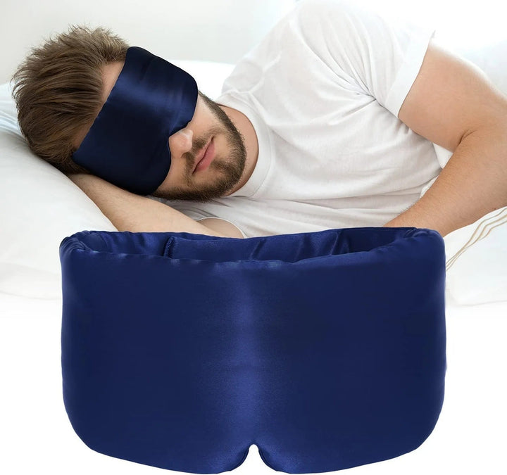 Person wearing a sleek black silk sleep mask, blocking light for restful sleep. Comfortable eye mask.