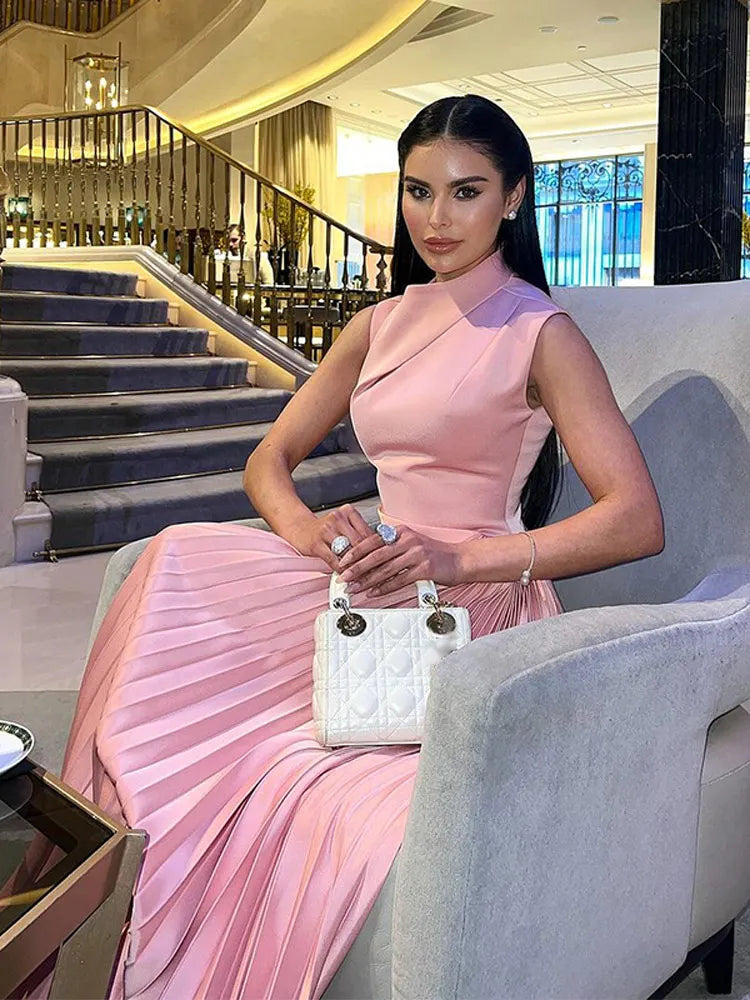 Women's formal pink pleated maxi dress, ideal for wedding guests & evening parties. Elegant sleeveless mock neck style.