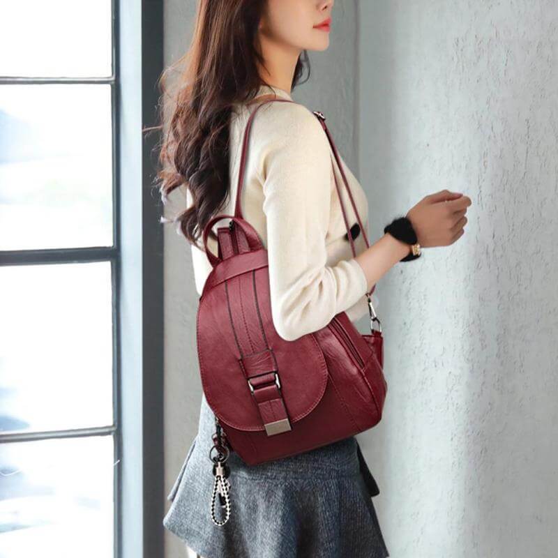 Women's designer-style water-resistant leather backpack. Functional anti-theft travel bag.