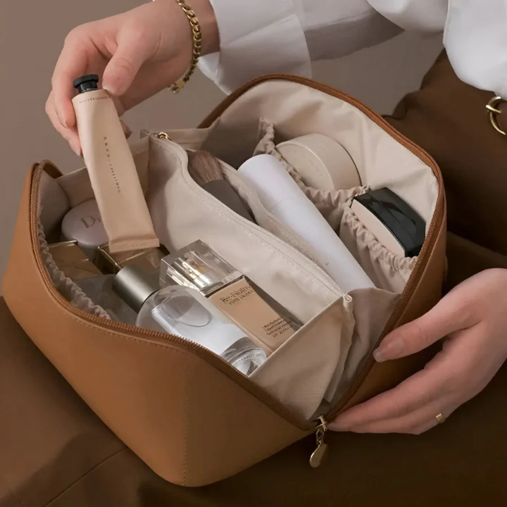 Pink travel makeup pouch, a waterproof beauty organizer for women's cosmetics and toiletries.