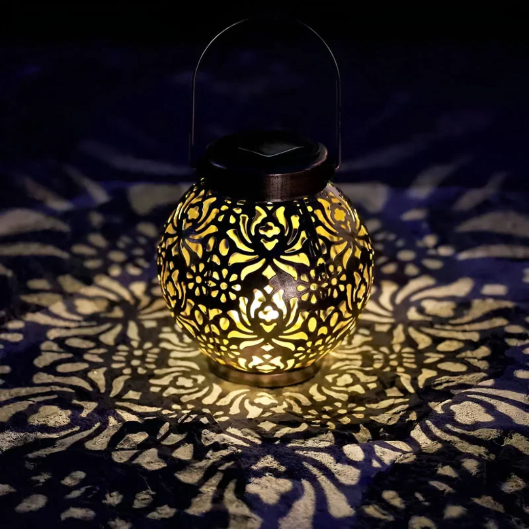 Decorative wrought iron solar LED garden lantern. Provides warm, ambient outdoor lighting for patios.