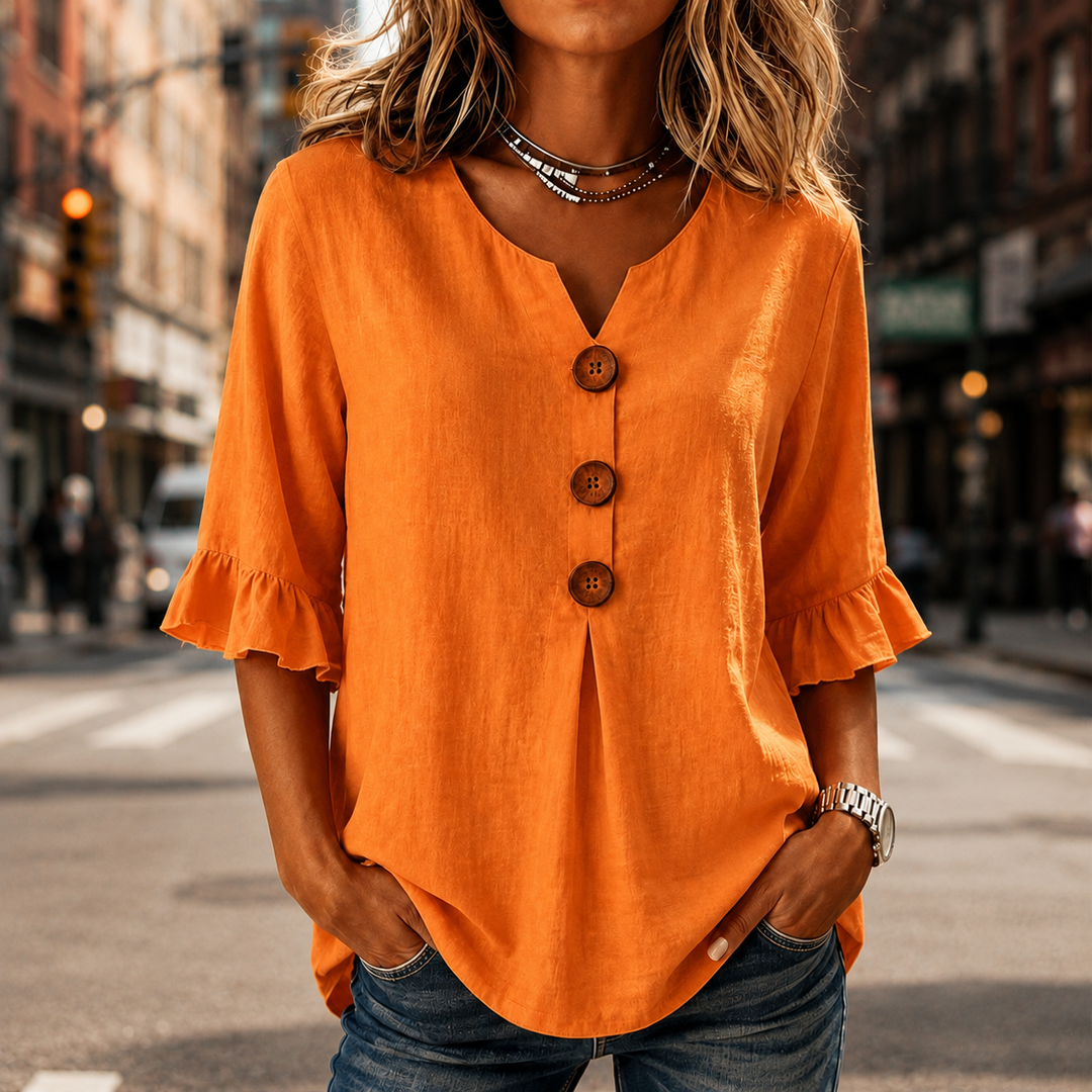 Winslow women's button-front ruffle sleeve blouse. Relaxed fit V-neck top for versatile everyday wear.