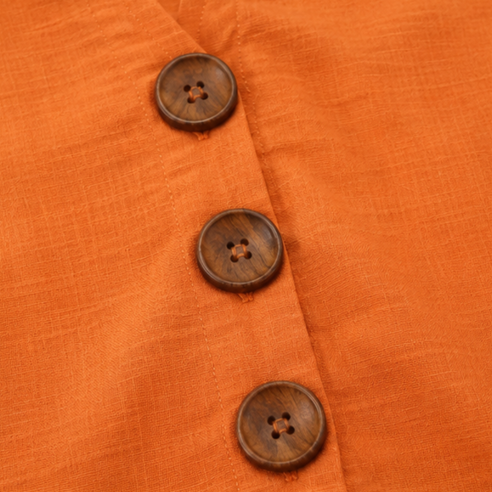 Winslow women's blouse in a vibrant color, featuring a button-front & flattering ruffle sleeves.