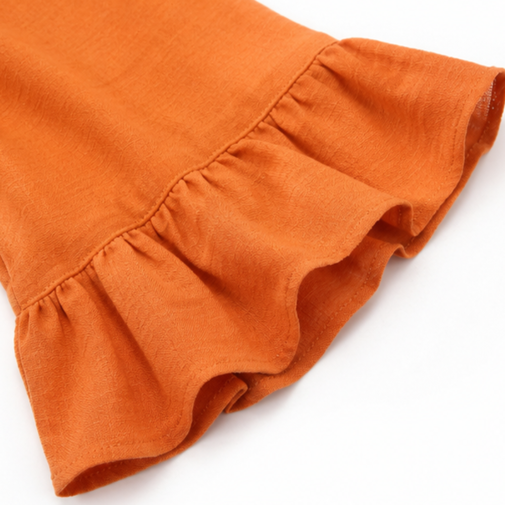 Elegant Winslow V-neck blouse with button-front & ruffle sleeves. Perfect for versatile spring fashion.