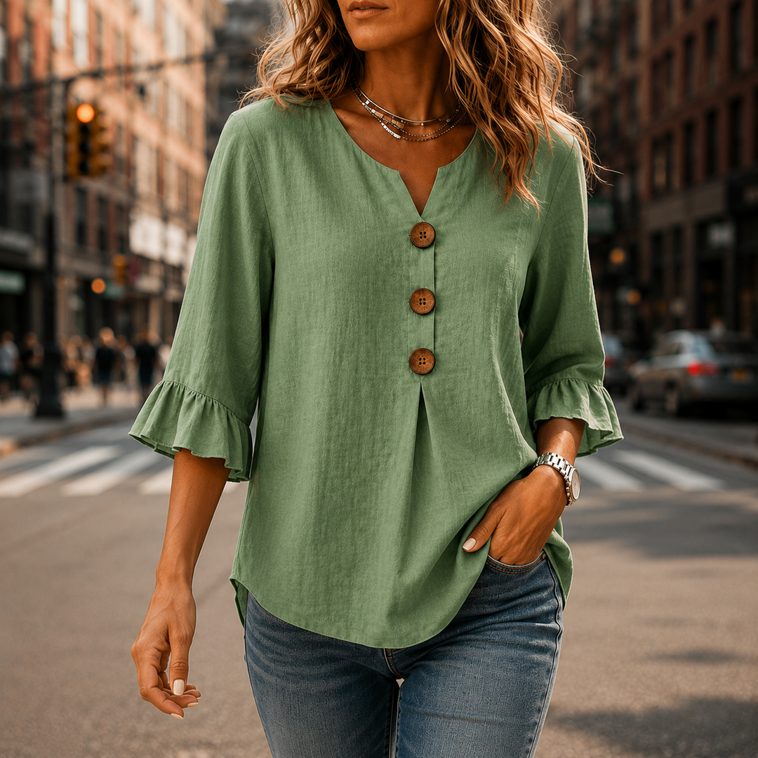Detailed view of the intricate ruffle sleeves and quality buttons on the Winslow V-neck blouse.