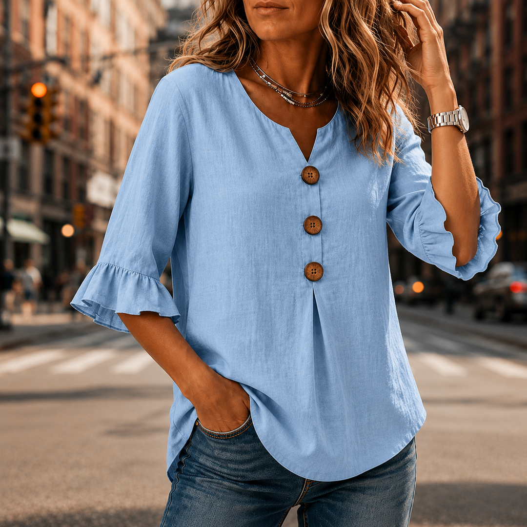 Woman moving in a Winslow relaxed fit blouse, showing the flow of the ruffle sleeves & fabric.