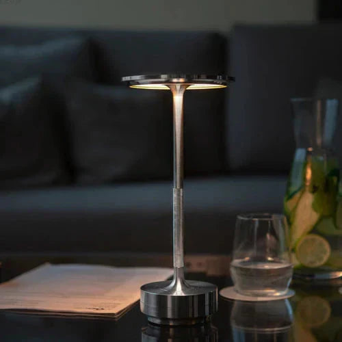 Sleek portable table lamp, wireless & USB rechargeable, providing dimmable ambient lighting.