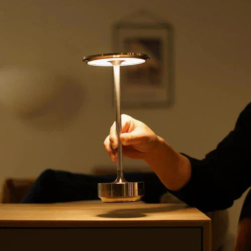 Rechargeable table lamp, USB powered, offers portable dimmable light for any room's decor.