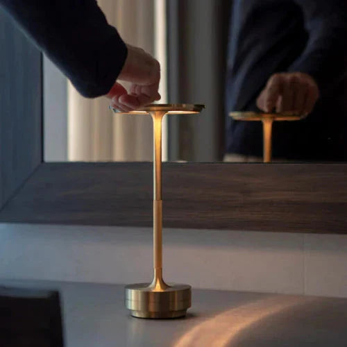 Elegant wireless table lamp, USB rechargeable, provides soft dimmable light for cozy ambient decor.