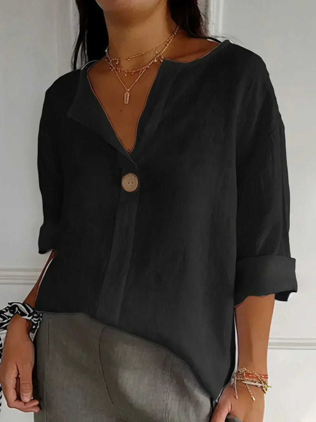 Comfortable women's oversized V-neck blouse with 3/4 sleeves, a stylish button-down top for effortless casual elegance.
