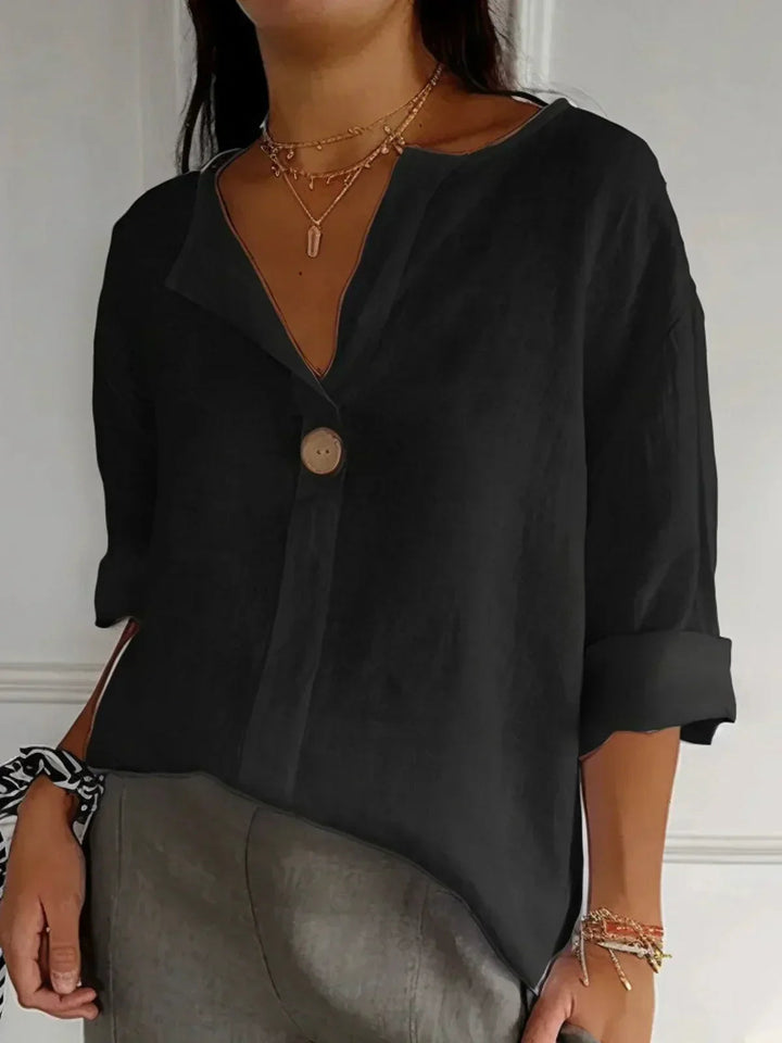Comfortable women's oversized V-neck blouse with 3/4 sleeves, a stylish button-down top for effortless casual elegance.
