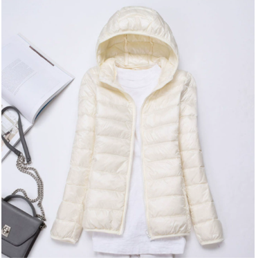 Fashionable women's lightweight puffer jacket. Hooded and quilted, offering stylish warmth for fall & winter.