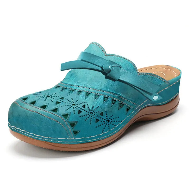 Comfortable women's slip-on clogs with a chic bow accent and unique cutout design, great for casual style.