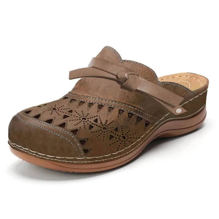 Fashionable women's flat clogs, perfect slip-on casual footwear for warm weather and comfortable everyday style.