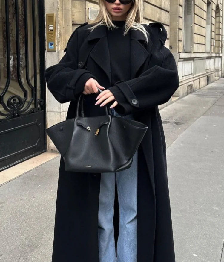 Timeless women's double-breasted classic black trench coat. Versatile, elegant long outerwear for seasonal fashion.