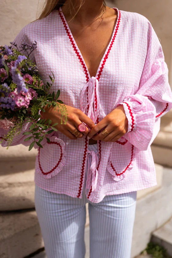 Feminine women's tie-front blouse with long puff sleeves & ruffle detail, ideal for summer chic.