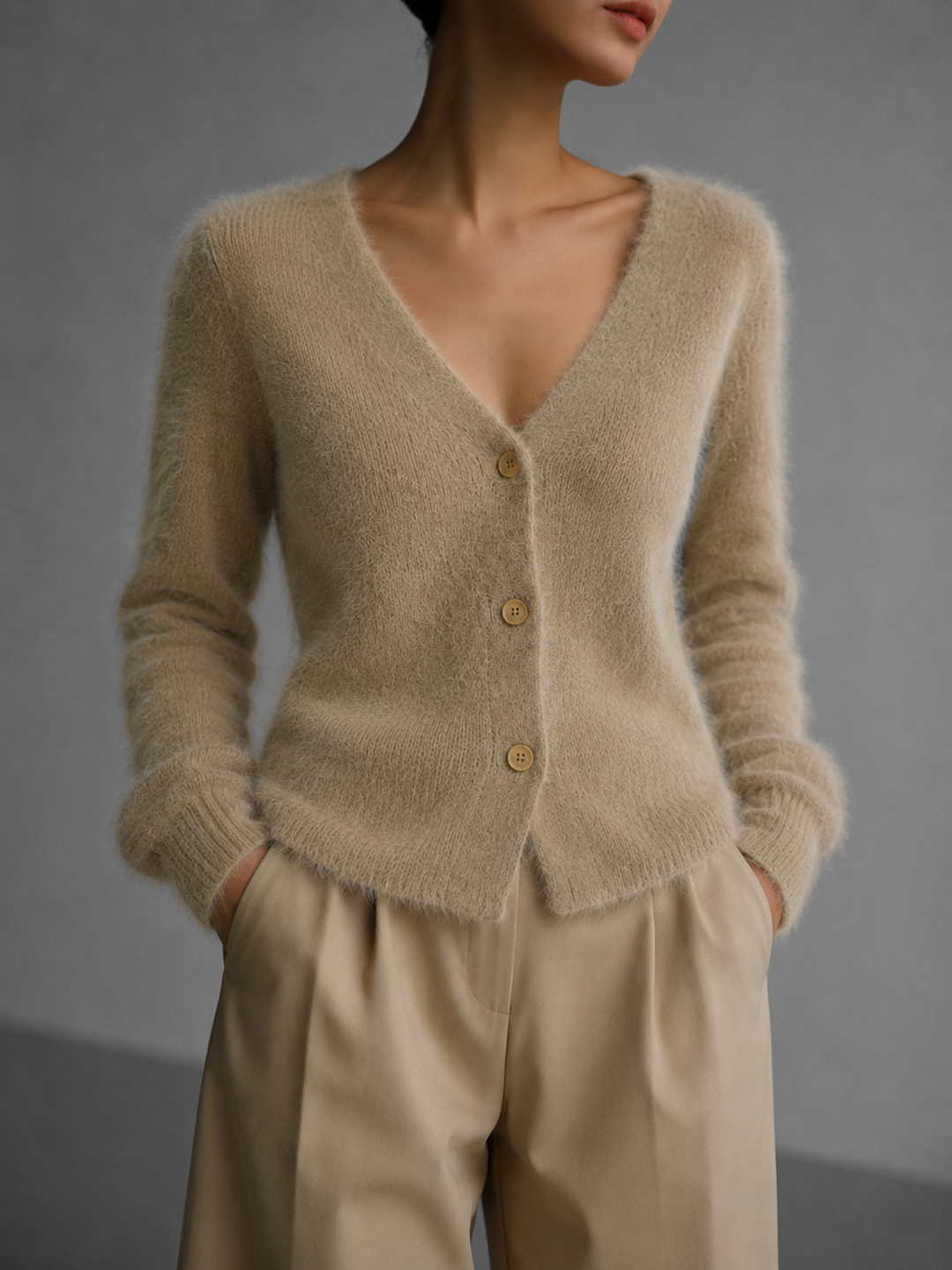 Versatile women's oversized grey button-up cardigan. Cozy, relaxed fit knitwear, ideal for casual layering fashion.