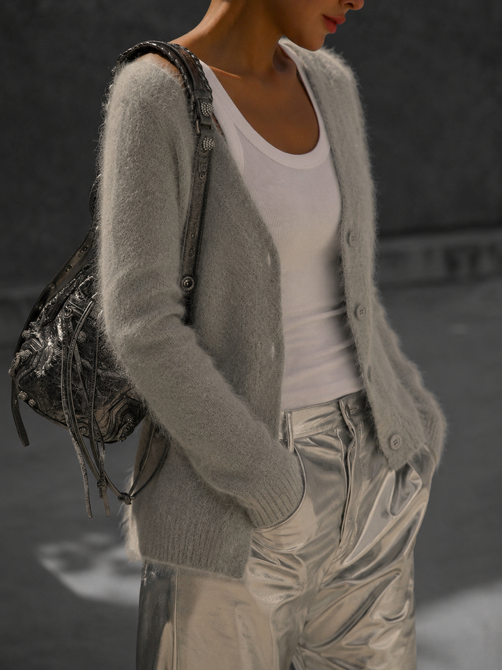 Soft white oversized button-up cardigan for women. Relaxed fit, long-sleeve knitwear, perfect for cozy casual style.
