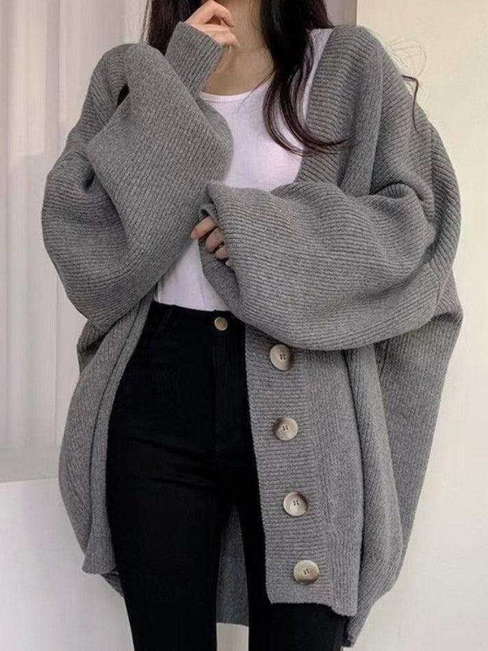 Modern women's oversized ribbed cardigan, a comfortable button-front V-neck layering piece perfect for casual elegance.