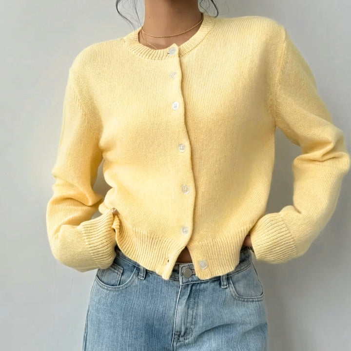 Soft knit women's cropped cardigan, stylish button-up top with comfortable ribbed cuffs.