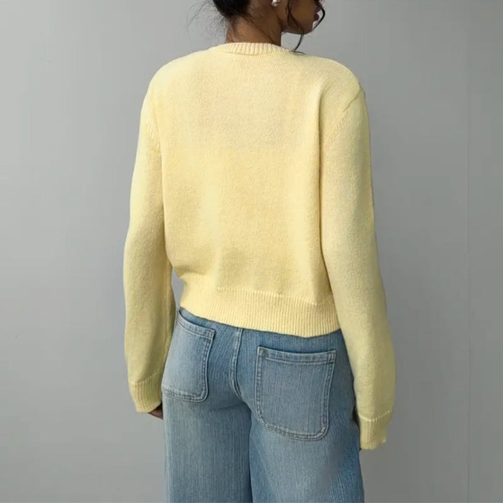 Flattering women's cropped cardigan, elegant button-up design with modern ribbed trim.