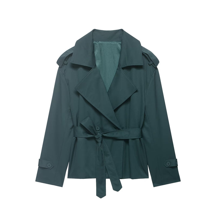 Fashionable women's cropped trench coat. Lightweight outerwear with a stylish belted waist and prominent oversized lapels.