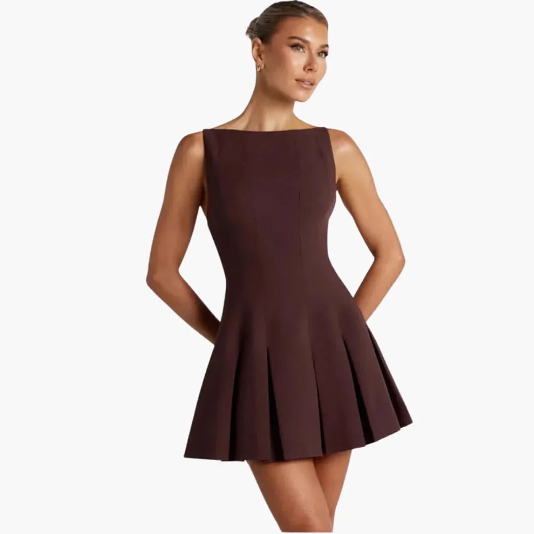 Sophisticated backless mini dress for women, featuring chic box pleats & thin spaghetti straps. Ideal for homecoming.