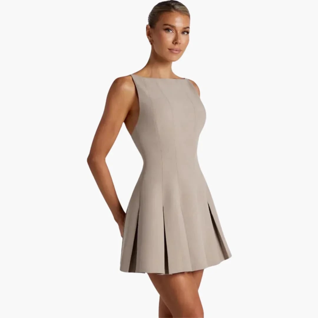 Versatile women's backless mini dress with graceful box pleats & spaghetti straps. Suitable for various events.