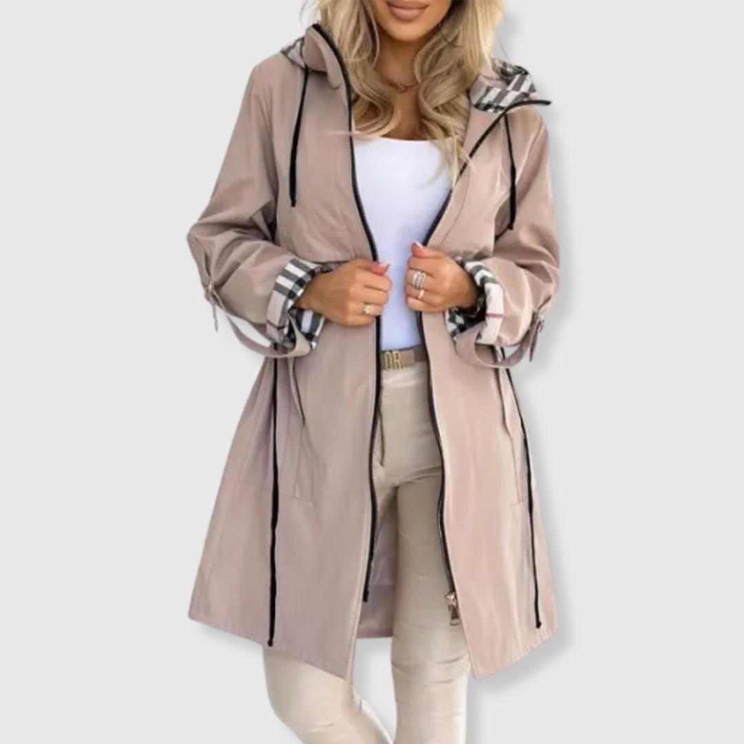 Waterproof women's long rain jacket. Features a stylish hood & cozy plaid lining, ideal for versatile outdoor wear.