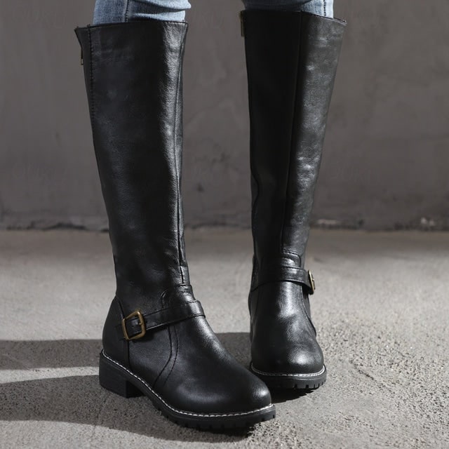 Comfortable brown women's tall boots. Features a stylish buckle, easy-access zipper, and rugged lug sole for grip.