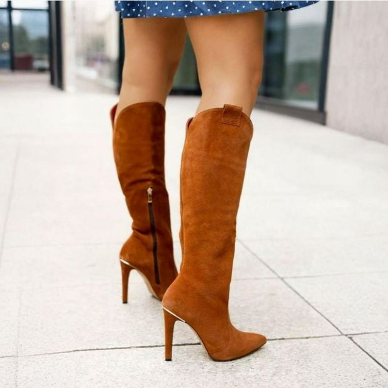Striking women's knee-high fashion boots, featuring a pointed toe and a sleek stiletto heel. Elevate your style.