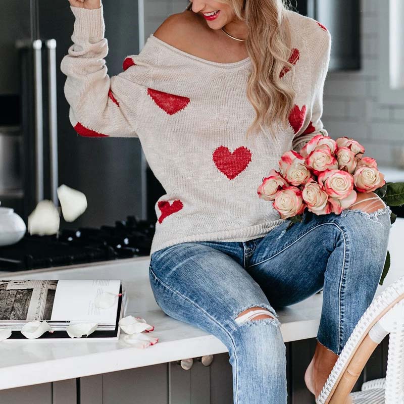 Soft knit V-neck sweater for women, adorned with a playful heart pattern, great for comfort.