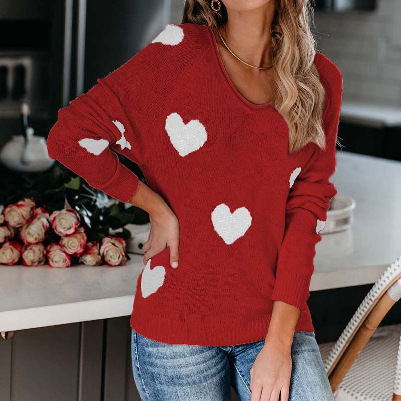 Relaxed fit V-neck knit sweater for women, with a playful heart print, perfect for everyday comfort.