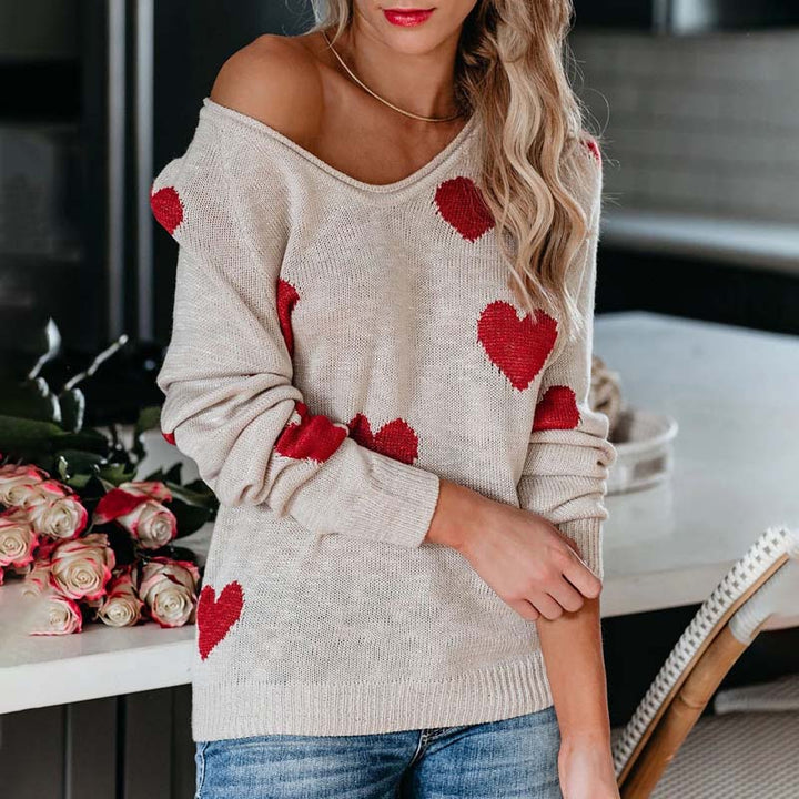Chic women's V-neck knit sweater, patterned with a unique heart print for a stylish look.