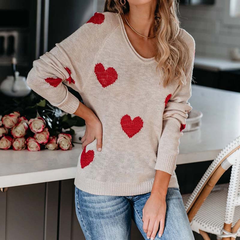 Women's V-neck knit sweater with playful heart print, ideal for cozy casual style.