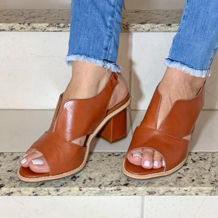 Selina women's heeled leather sandals with adjustable buckle, featuring an ergonomic comfort footbed.