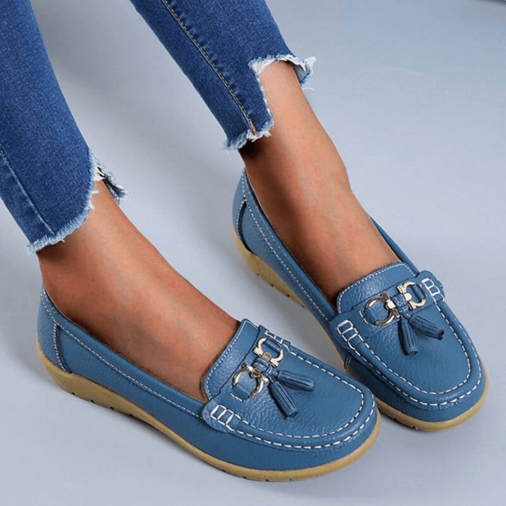 Women's light blue slip-on loafers with tassels, offering comfortable casual everyday style for women.
